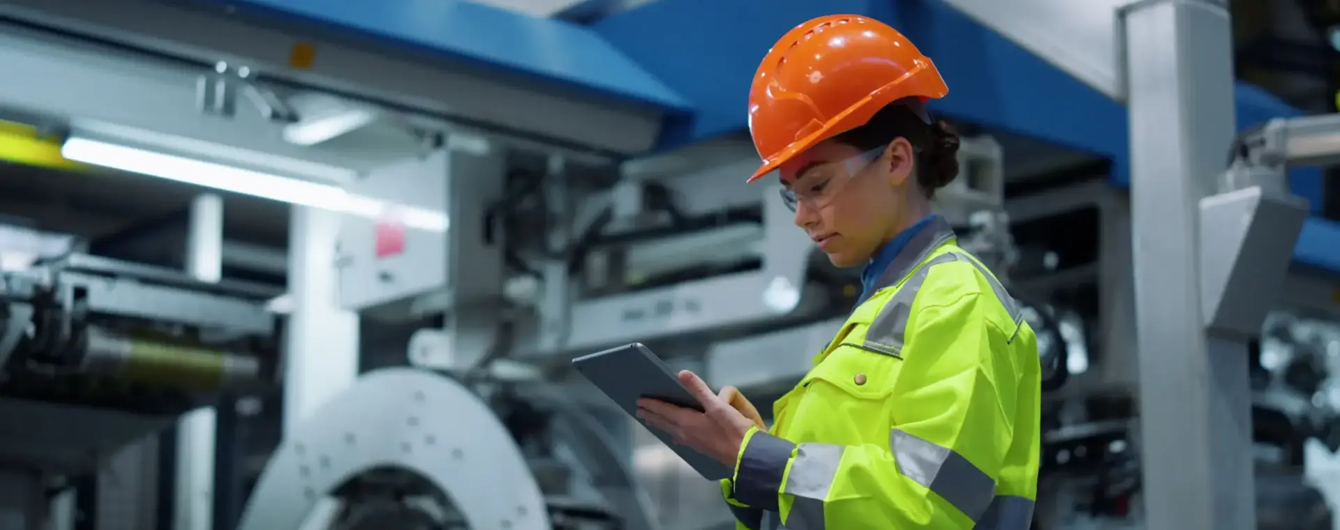 student in werkkleding controleert installatie met behulp van tablet