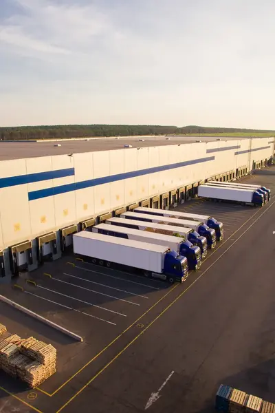 Distributiecentrum met vrachtwagens die worden bevoorraad.